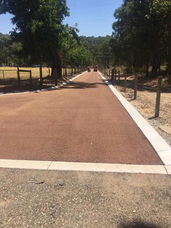 This is a photo of a hot spray & seal bitumen roadway which is in the process of being installed by Ballarat Road Tech